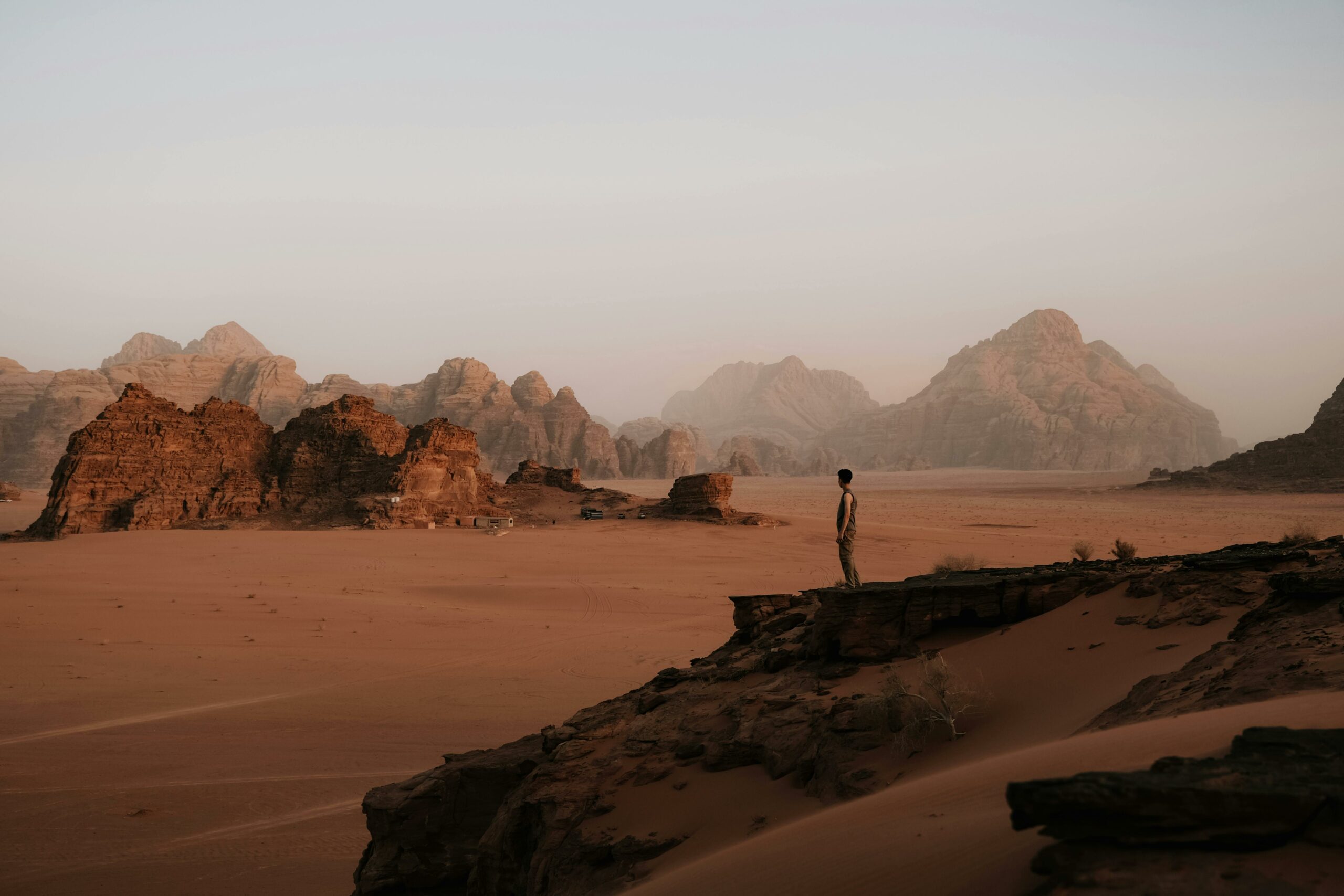 Explore the vast and breathtaking landscapes of Wadi Rum, Jordan's iconic desert, at sunset.