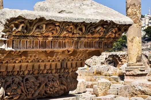 Close-up of detailed carvings on ancient Roman ruins, showcasing ornate stonework in a historic site.